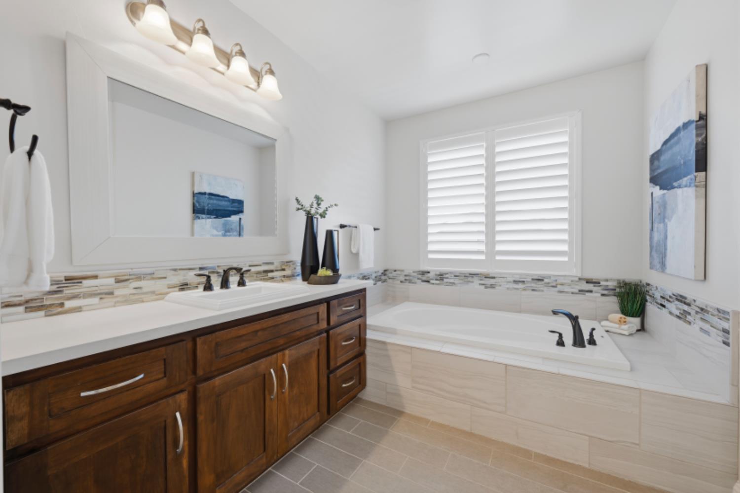 2714 Hidden Trail Loop Rocklin, CA 95765 - Photo 37 of 57 a bathroom with a tub sink and mirror