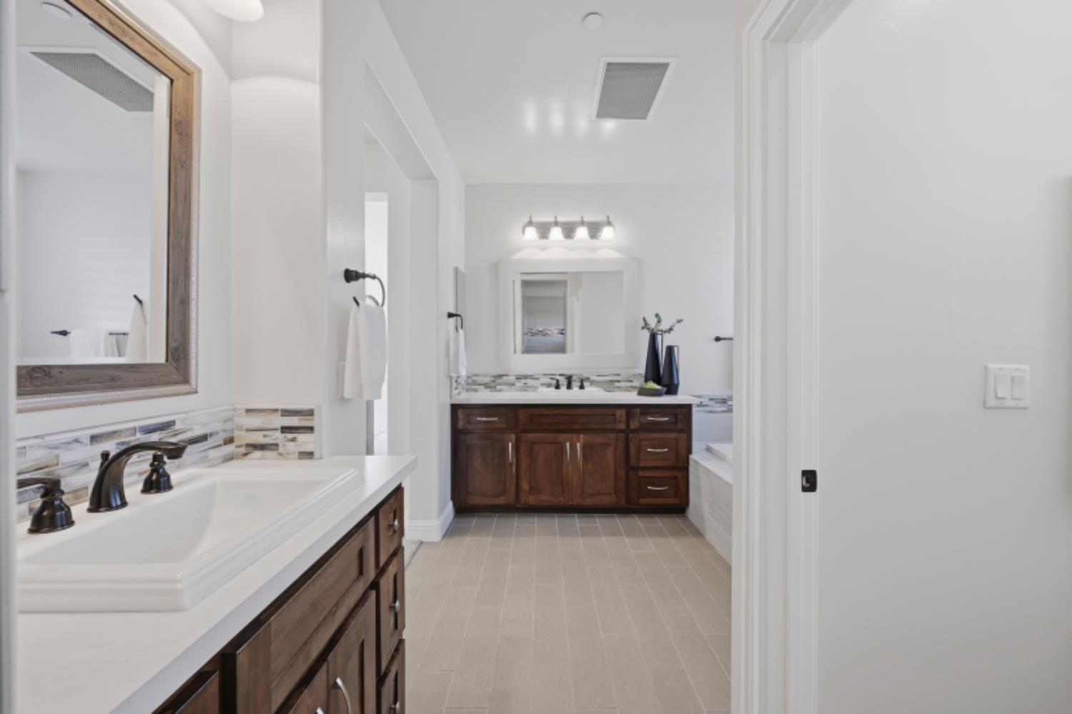 2714 Hidden Trail Loop Rocklin, CA 95765 - Photo 38 of 57 a bathroom with a sink vanity granite tub and a mirror