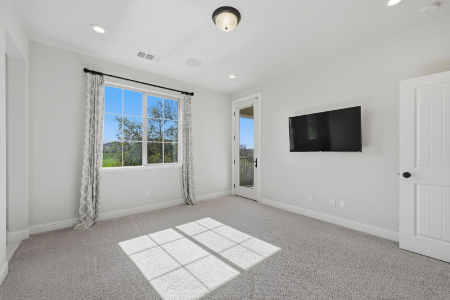 2714 Hidden Trail Loop Rocklin, CA 95765 - Photo 41 of 57 a view of an empty room with a window and a flat screen tv
