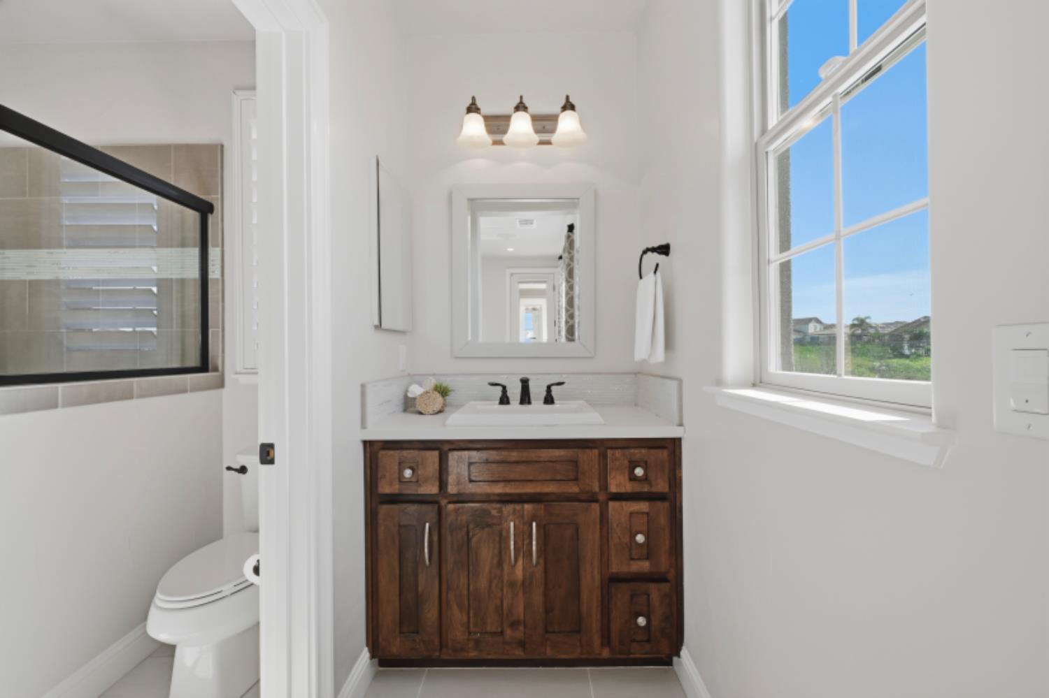 2714 Hidden Trail Loop Rocklin, CA 95765 - Photo 44 of 57 a bathroom with a sink a toilet and a mirror
