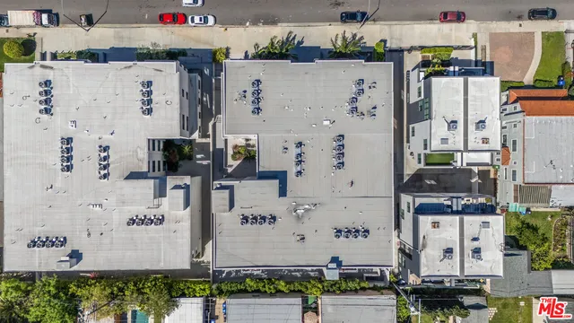an aerial view of residential houses with city view