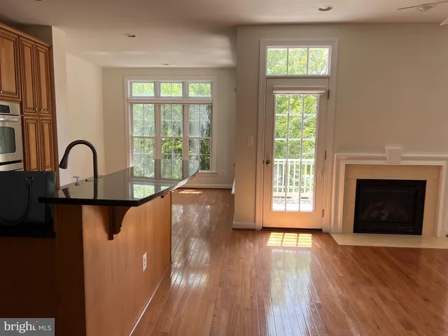 a kitchen with kitchen island granite countertop wooden floors and stainless steel appliances