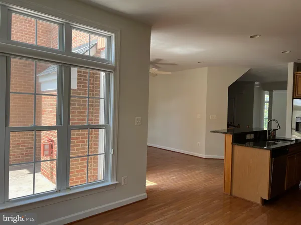 a view of a livingroom with wooden floor and a fireplace