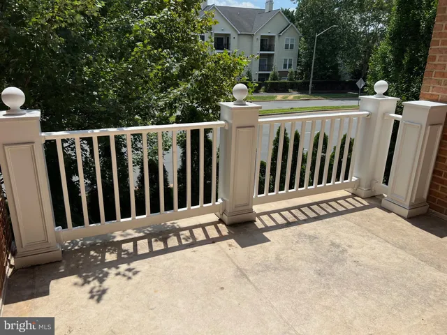 an empty room with windows and fireplace