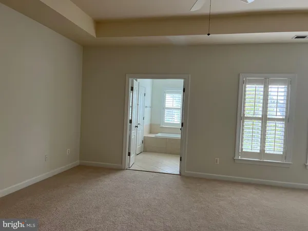 a view of staircase with white walls and railing