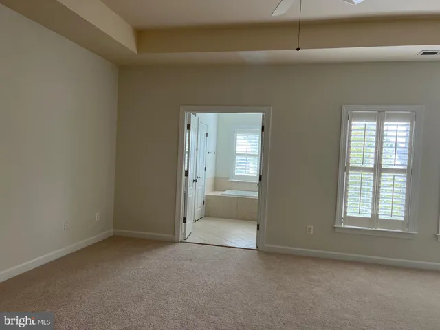 a view of staircase with white walls and railing