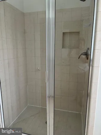 a bathroom with a glass door shower