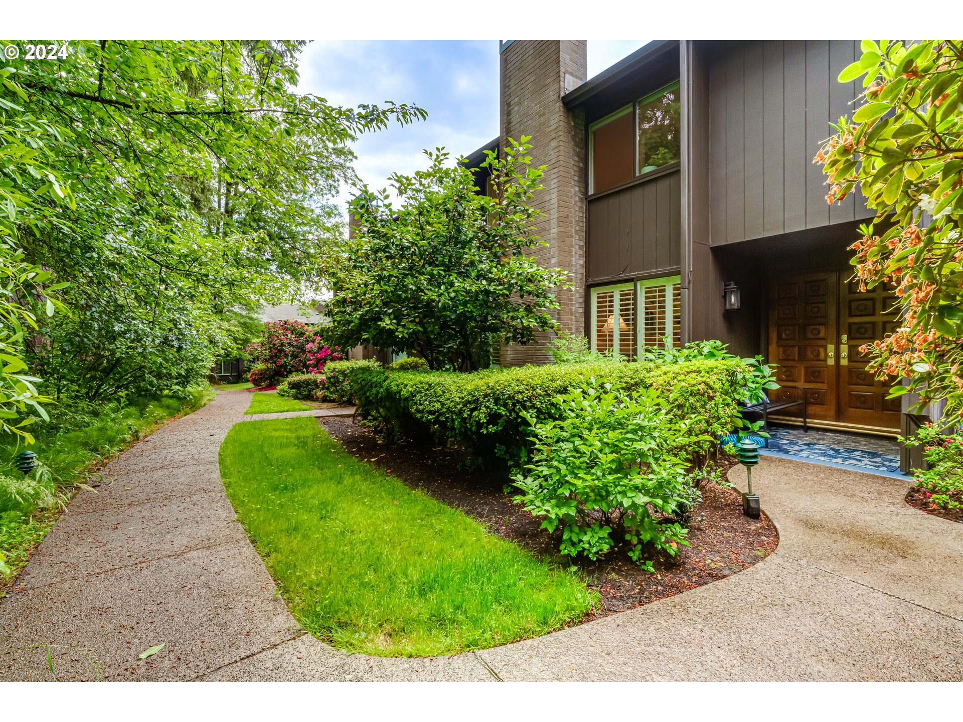 145 Westbrook Way Eugene, OR 97405 - Photo 1 of 48 a view of a garden with a fountain