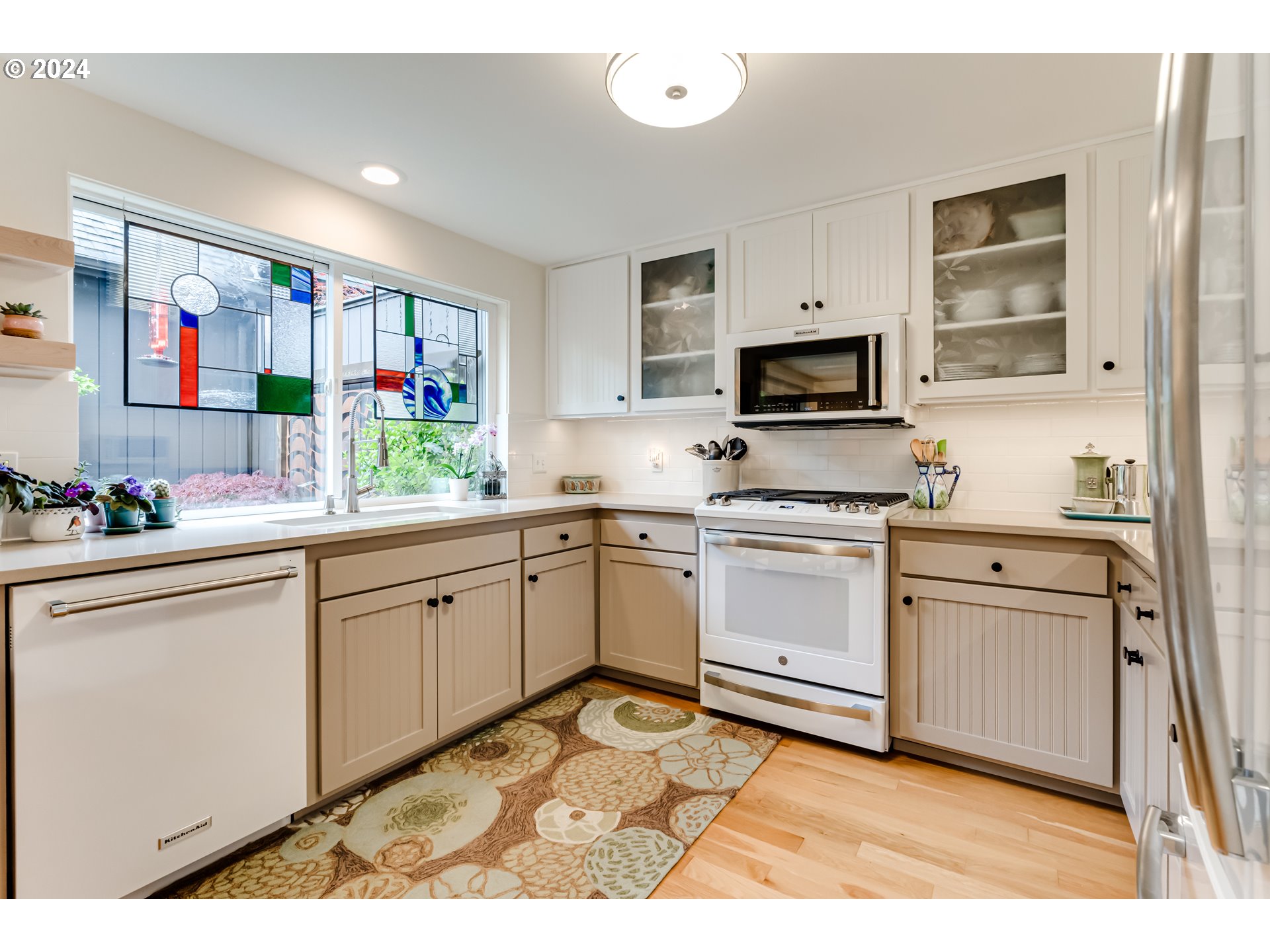 145 Westbrook Way Eugene, OR 97405 - Photo 15 of 48 a kitchen with granite countertop white cabinets and white appliances