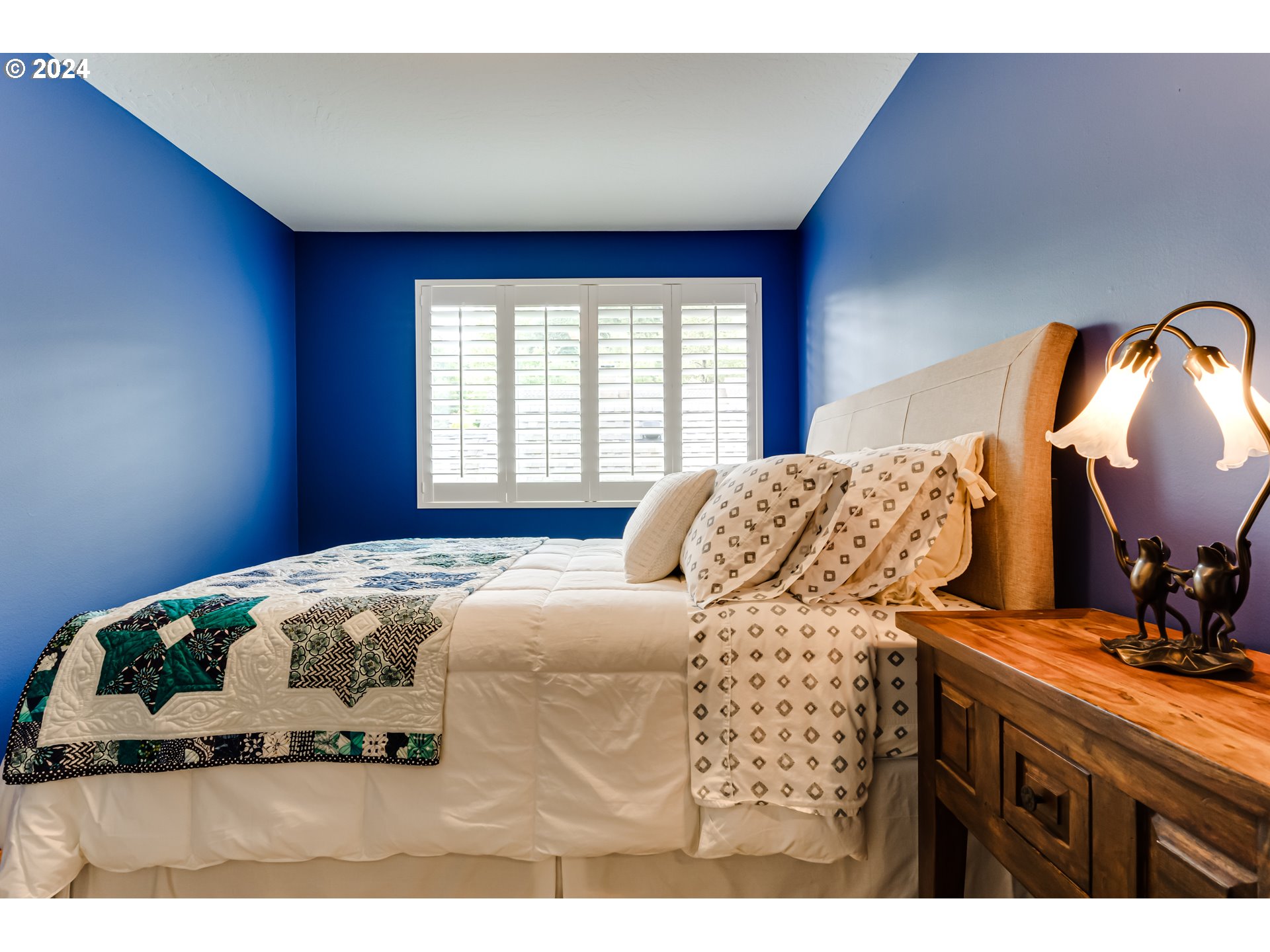 145 Westbrook Way Eugene, OR 97405 - Photo 34 of 48 a bedroom with a bed and wooden floor
