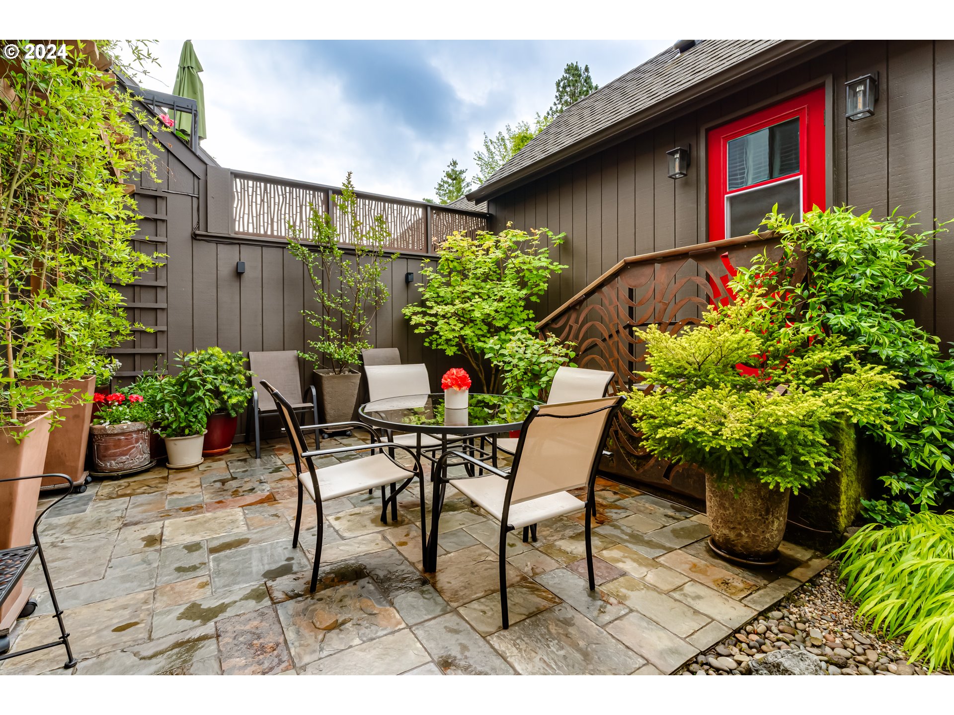 145 Westbrook Way Eugene, OR 97405 - Photo 39 of 48 a backyard of a house with table and chairs potted plants