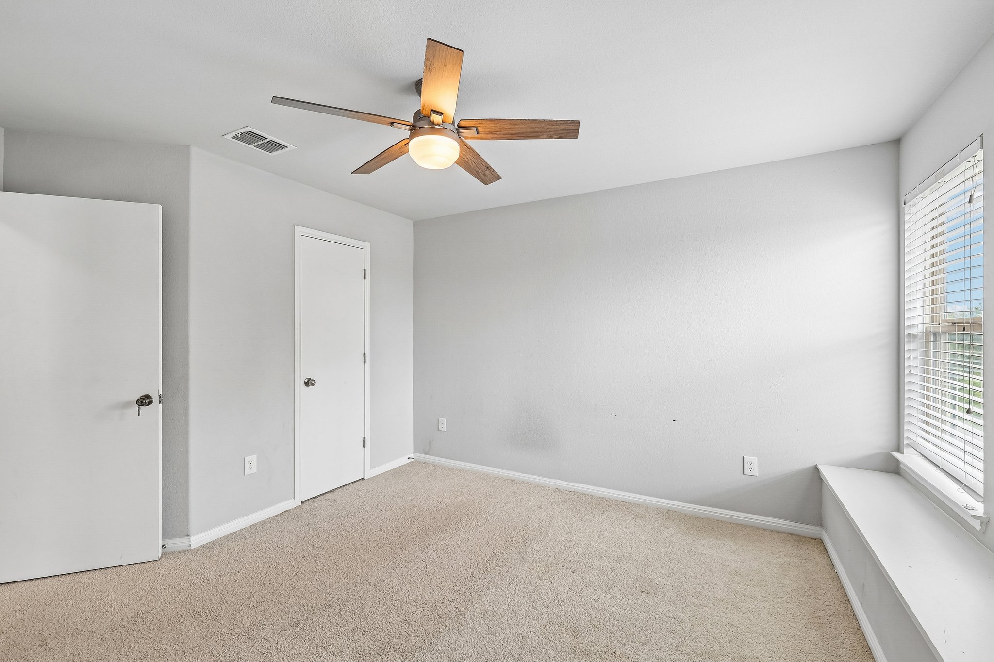 387 Guemal Road Buda, TX 78610 - Photo 27 of 39 Carpeted room featuring a ceiling fan with light fixture, window with horizontal blinds, and a built-in window bench