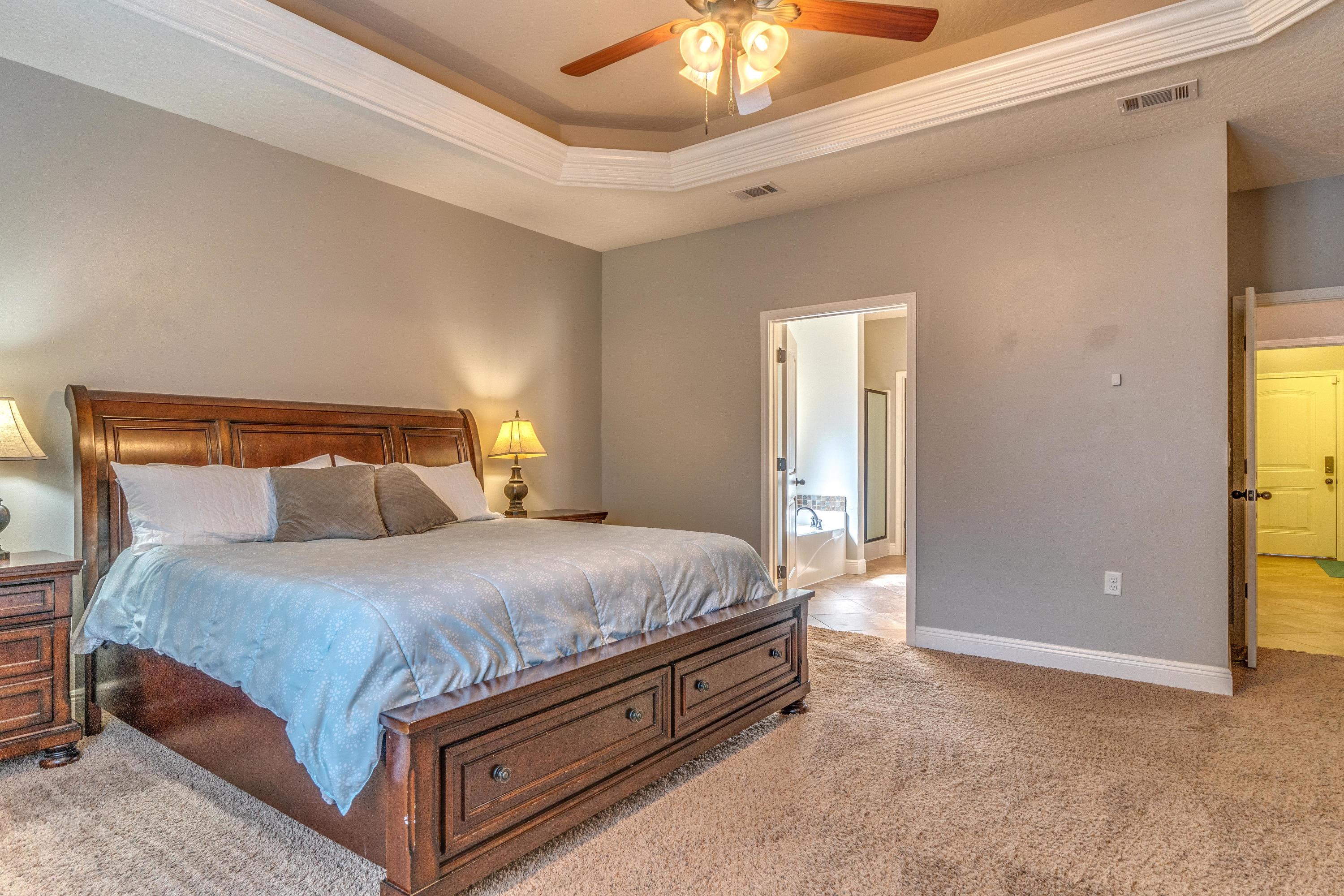4624 Hermosa Road Crestview, FL 32539 - Photo 14 of 32 a bed sitting in a bedroom next to a bathroom