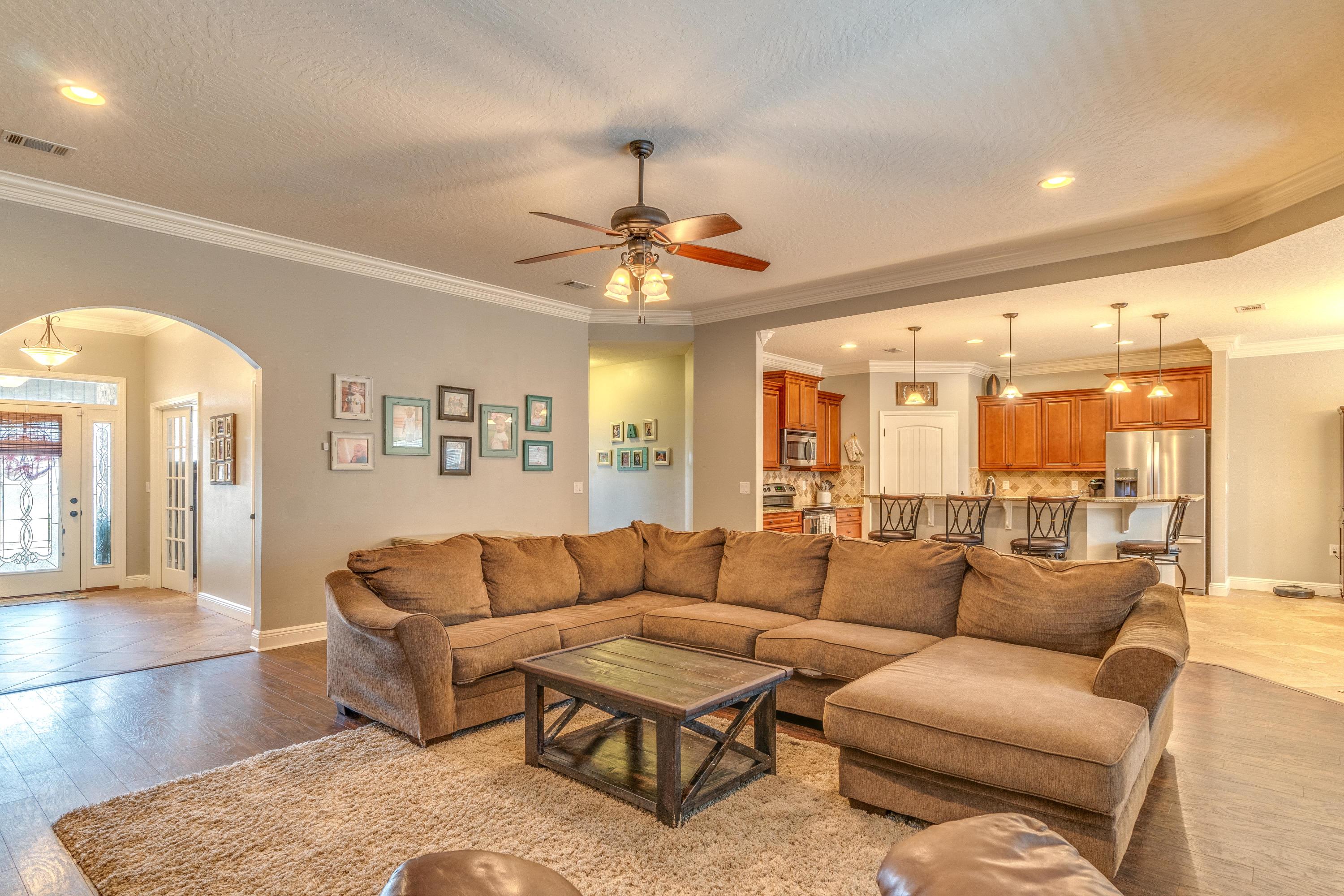 4624 Hermosa Road Crestview, FL 32539 - Photo 5 of 32 a living room with furniture a chandelier and a chandelier