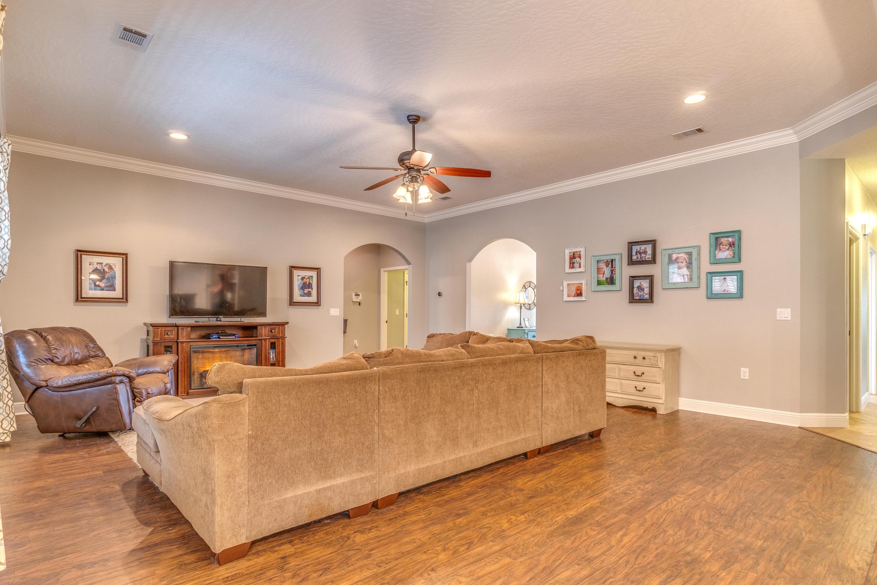 4624 Hermosa Road Crestview, FL 32539 - Photo 7 of 32 a living room with furniture and a flat screen tv