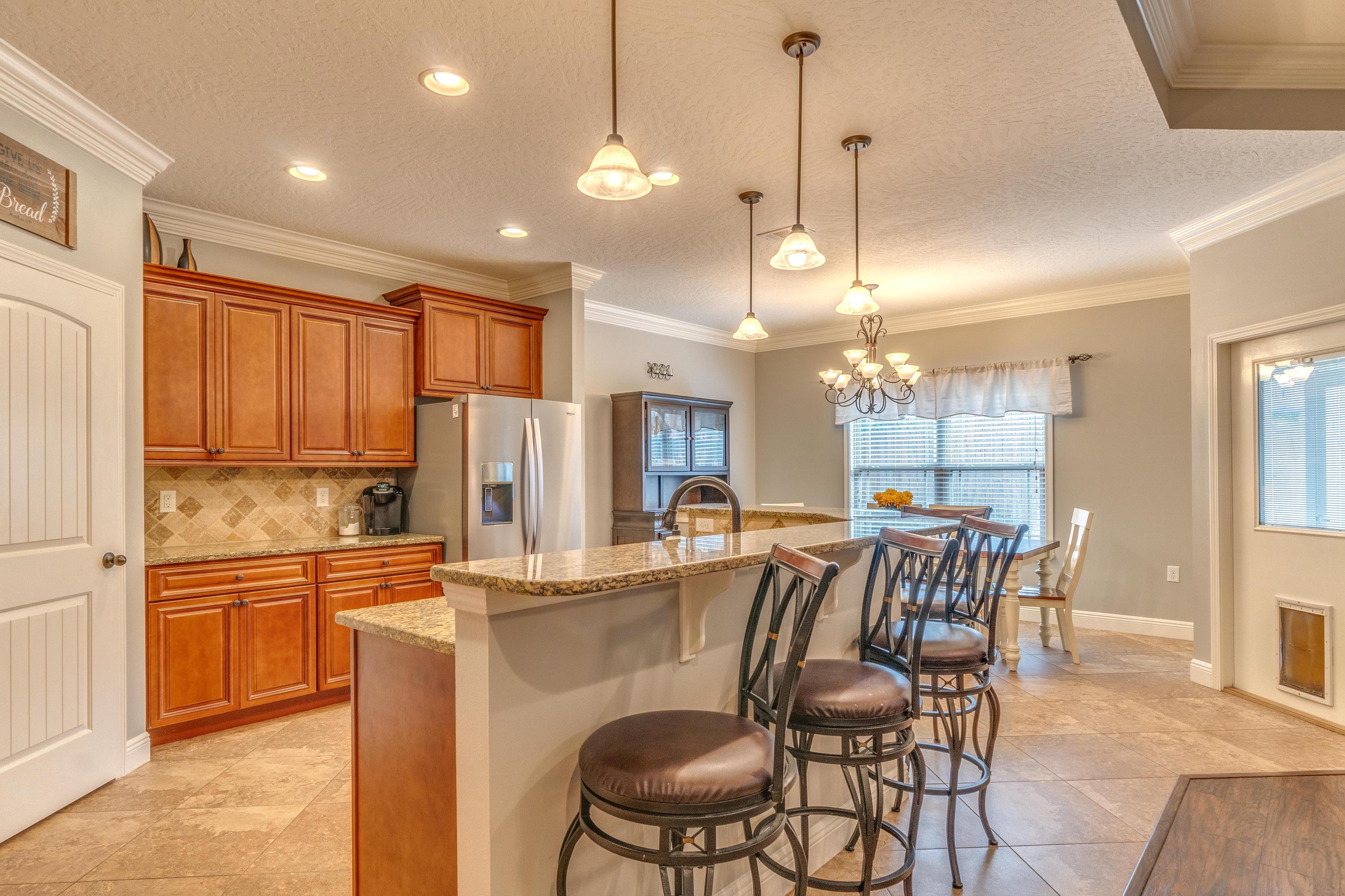4624 Hermosa Road Crestview, FL 32539 - Photo 9 of 32 a dining table with chairs and kitchen view