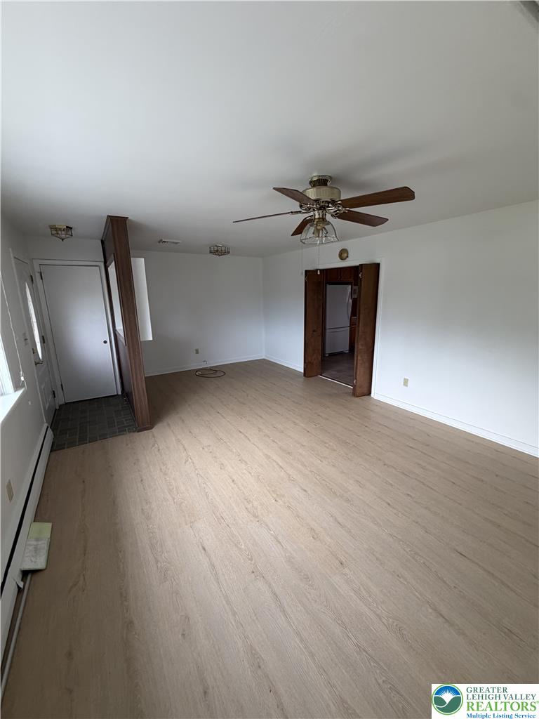 5391 Chapmans Road, Unit 2 Orefield, PA 18069 - Photo 12 of 22 A versatile living space with light-toned flooring, ready for personalization.