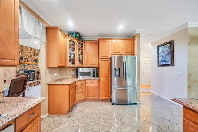 a kitchen with stainless steel appliances granite countertop a refrigerator and a sink