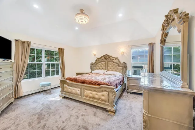 a bedroom with a bed and glass window