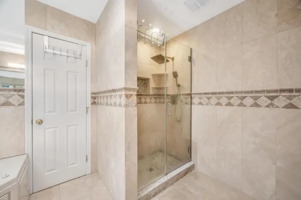 a bathroom with a glass shower door