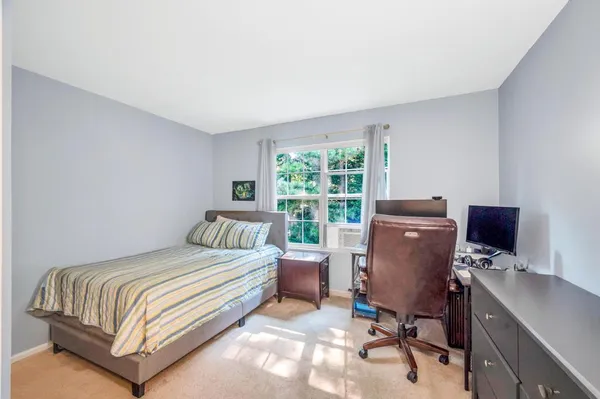 a bedroom with a bed and a desk