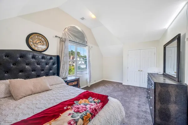 a bedroom with a bed and a chandelier