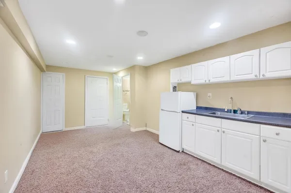 a kitchen with granite countertop white cabinets and stainless steel appliances