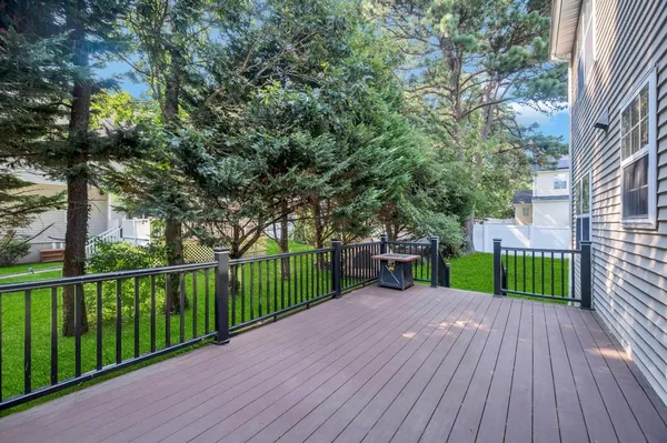 a view of a house with backyard and deck