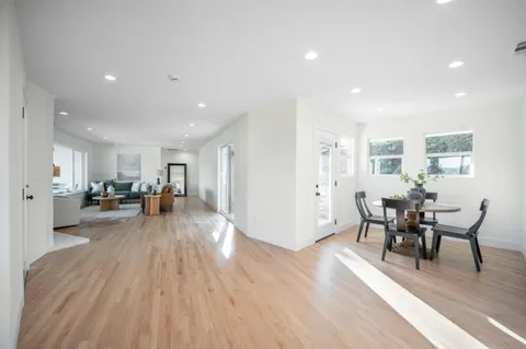 a living room with furniture fireplace and wooden floor