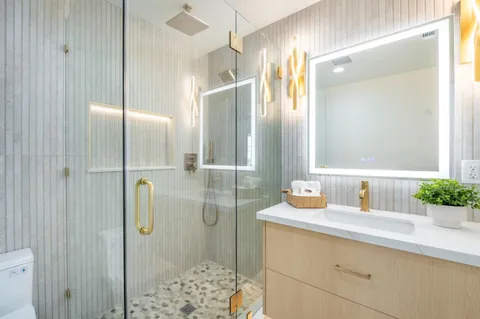 a front view of a house with a tree