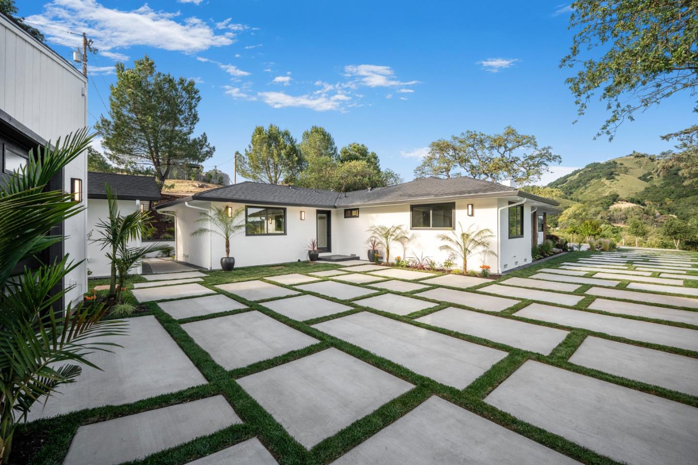 2275 Llagas Road Morgan Hill, CA 95037 - Photo 43 of 56 a view of a white house with a fountain plants and large tree