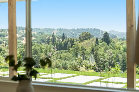 a living room with furniture and a mirror
