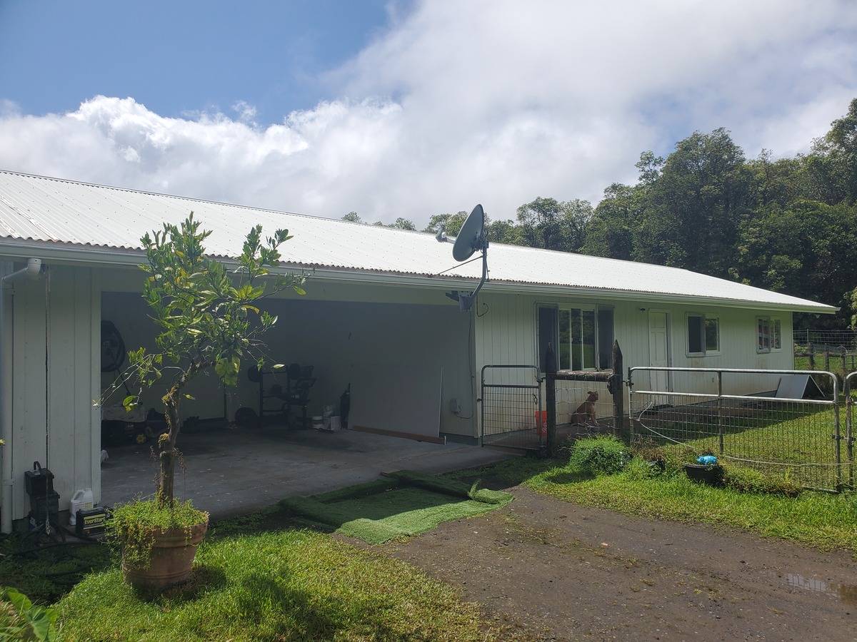 18-1455 Ihope Road Mountain View, HI 96771 - Photo 1 of 11 a front view of a house with garden