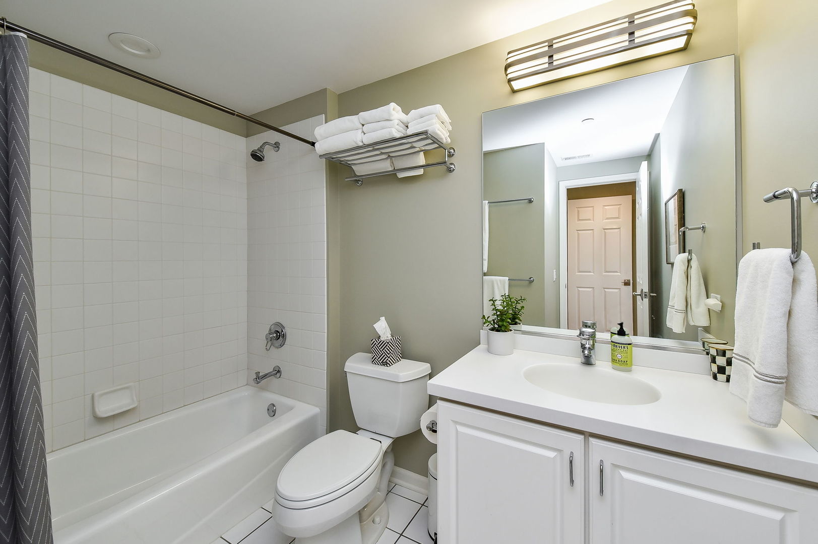 111 North Wheaton Avenue, Unit 407 Wheaton, IL 60187 - Photo 11 of 12 a bathroom with a sink a toilet and a mirror