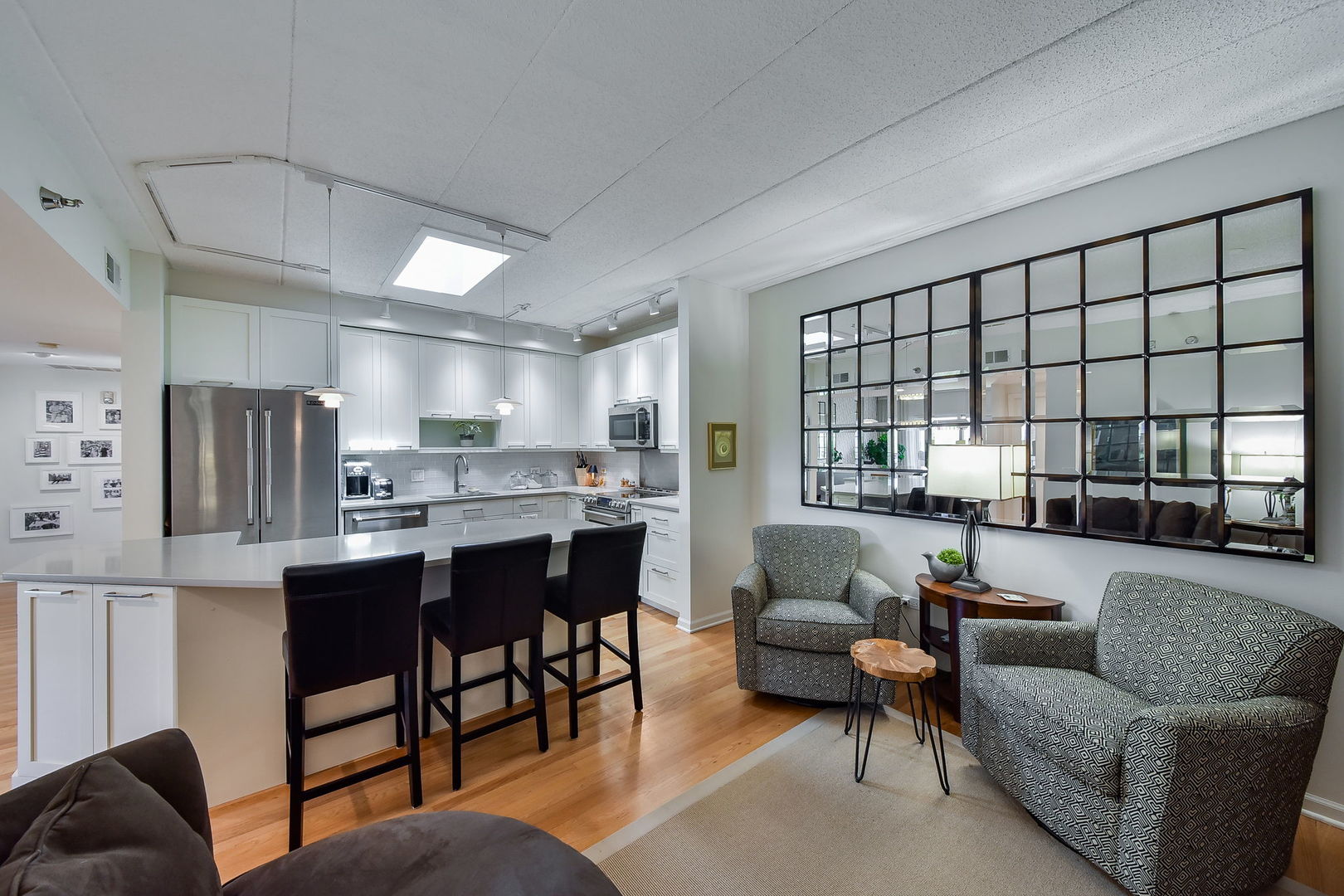 111 North Wheaton Avenue, Unit 407 Wheaton, IL 60187 - Photo 6 of 12 a living room with furniture and a large window