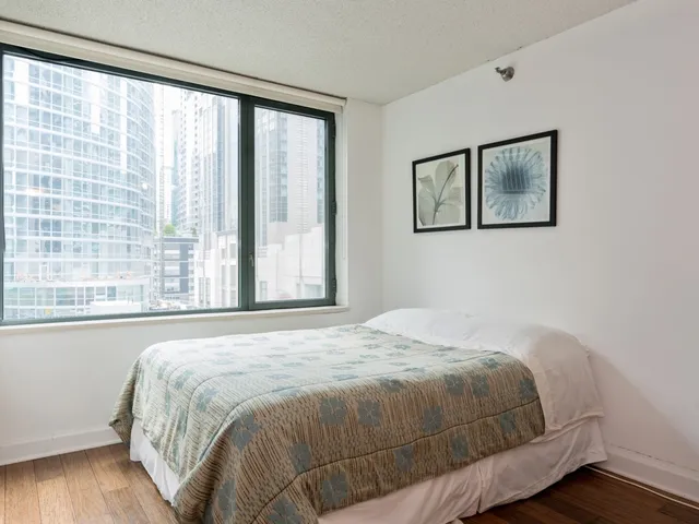 a bedroom with a bed and a large window