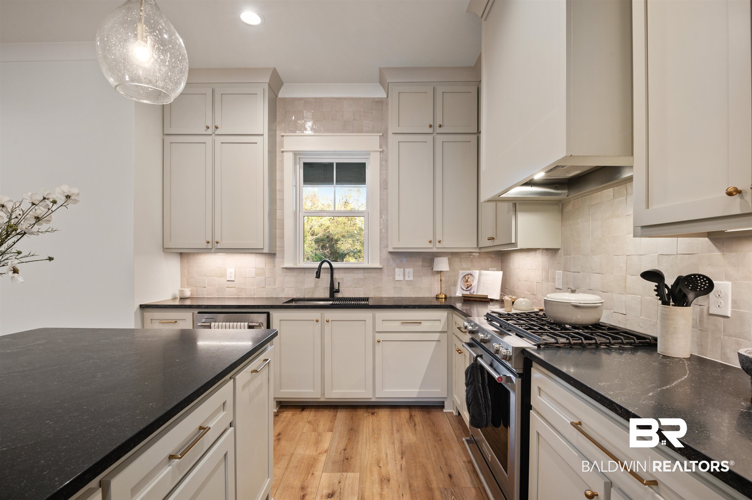 312 Pecan Ridge Boulevard Fairhope, AL 36532 - Photo 14 of 43 Kitchen featuring white cabinetry, custom exhaust hood, stainless steel appliances, pendant lighting, and sink