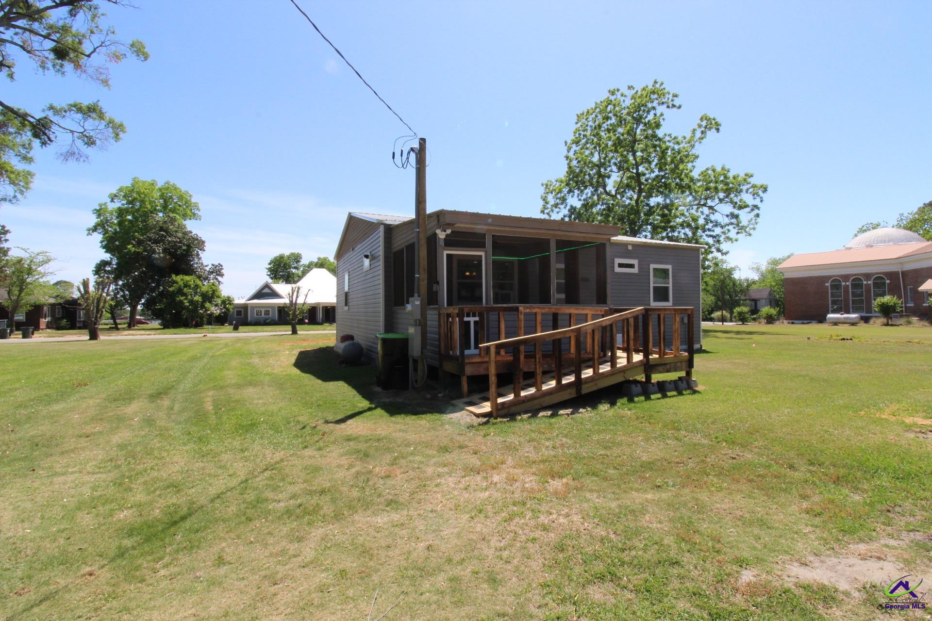 218 6th Avenue Rochelle, GA 31079 - Photo 19 of 22 a view of a house with yard and sitting area