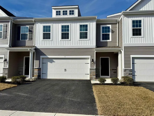 a view of a brick house with many windows