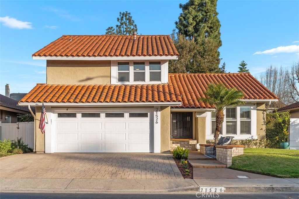 a front view of a house with garden and patio