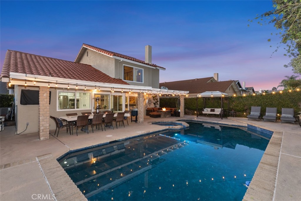 21526 Vía Serpiente Lake Forest, CA 92630 - Photo 32 of 51 a view of a patio with swimming pool table and chairs