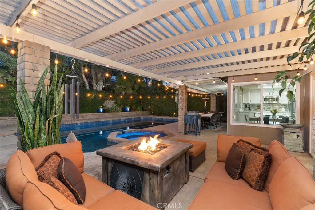 21526 Vía Serpiente Lake Forest, CA 92630 - Photo 35 of 51 a view of a couches and table in patio with a barbeque grill