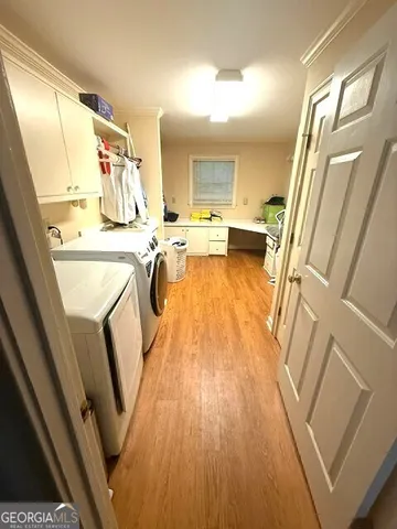 a view of a kitchen with wooden floor and furniture