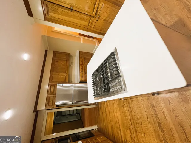 a kitchen with stainless steel appliances granite countertop a stove microwave and cabinets