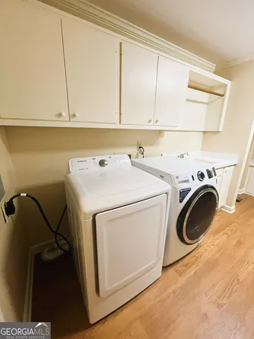 a view of a room with wooden floor and small window