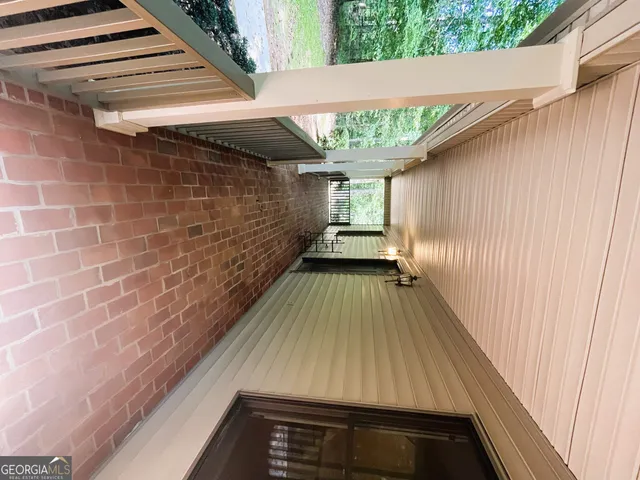 a view of a yard with plants and trees