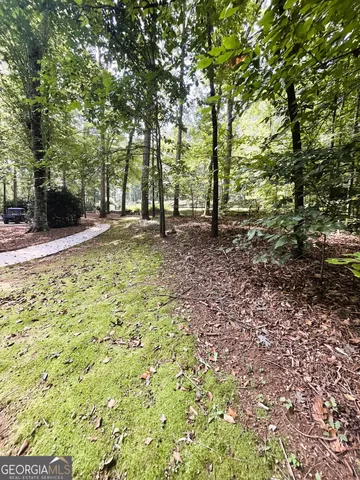 a balcony with wooden floor and trees