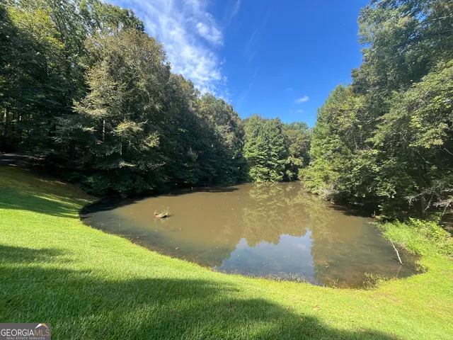 a view of a swimming pool with an outdoor space and seating area