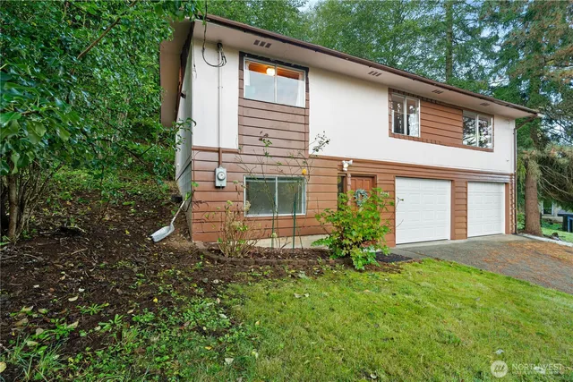 a front view of a house with a yard and garage