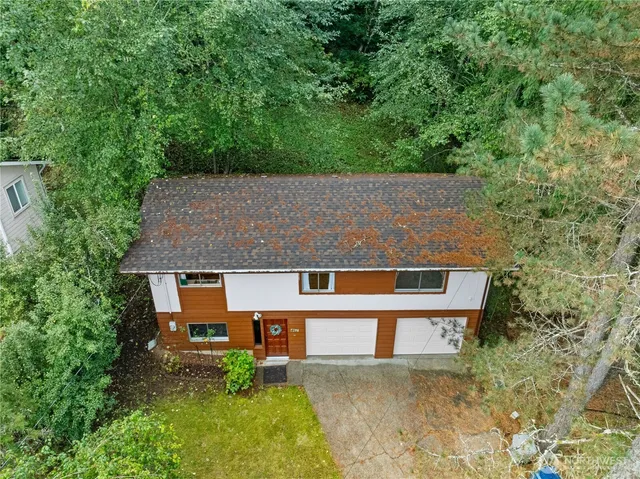 an aerial view of a house with a yard